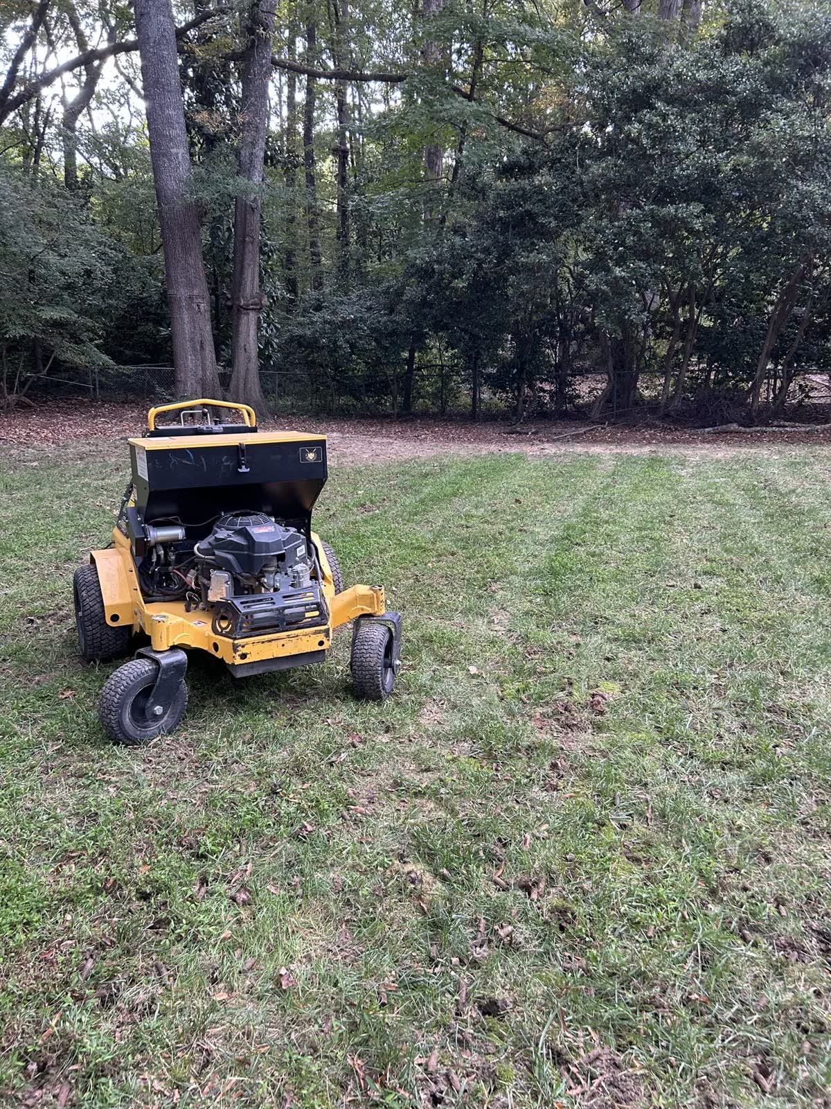 Core aeration equipment working across a lawn by Envision Landscaping
