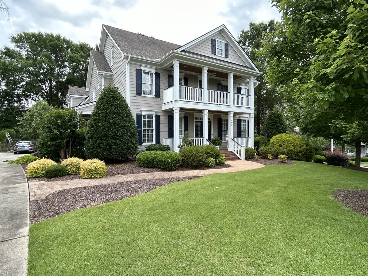 Wide finished lawn after routine care by Envision Landscaping