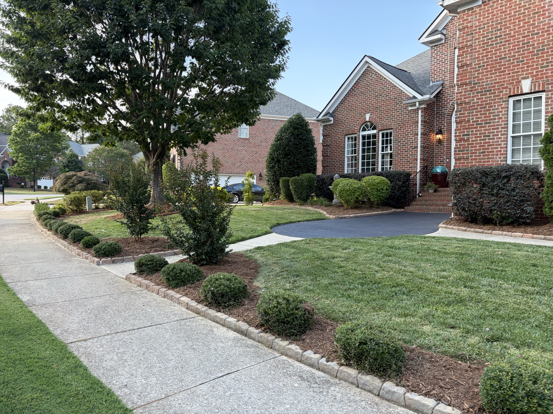 Finished residential entry landscape after trimming and bed maintenance
