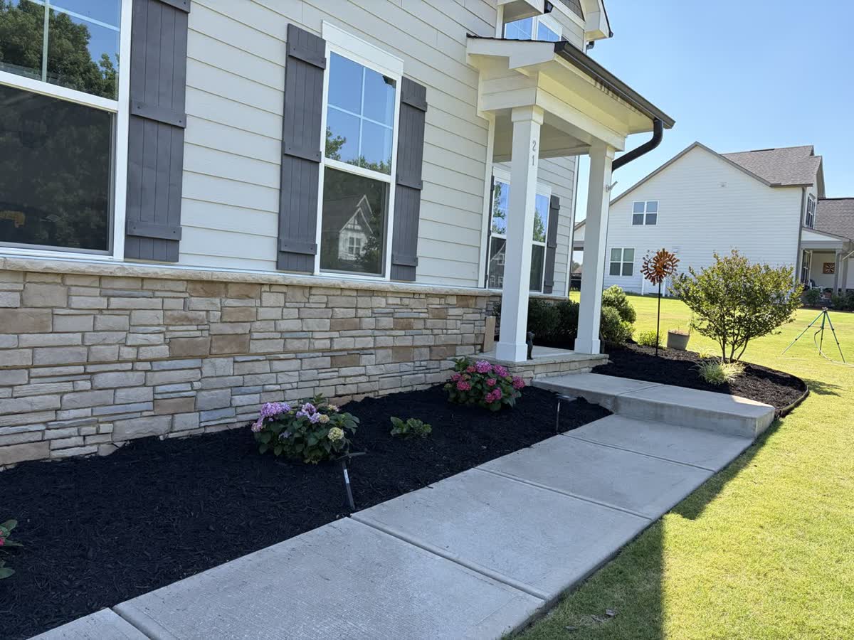 Fresh mulch installed along a foundation bed by Envision Landscaping
