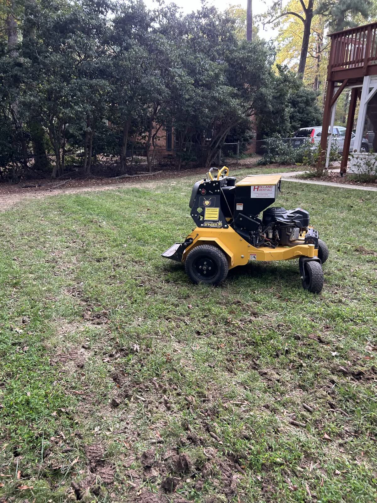 Equipment applying seed across an aerated lawn